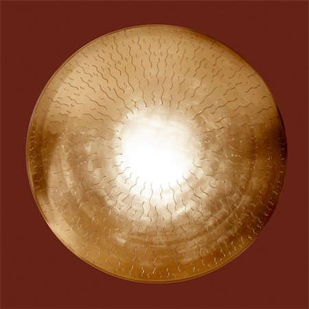 Asian brass gong golden round isolated on dark red Stock Photo - Budget Royalty-Free & Subscription, Code: 400-04774565