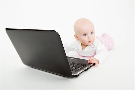 pzromashka (artist) - baby with laptop lying on a light background Foto de stock - Super Valor sin royalties y Suscripción, Código: 400-04774575