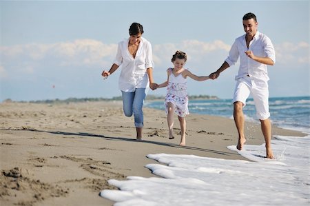 simsearch:400-05309800,k - happy young family in white clothing have fun at vacations on beautiful beach Stock Photo - Budget Royalty-Free & Subscription, Code: 400-04778666