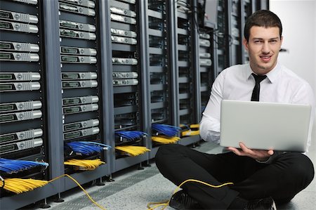 simsearch:400-05291415,k - young engeneer business man with thin modern aluminium laptop in network server room Stock Photo - Budget Royalty-Free & Subscription, Code: 400-04779228