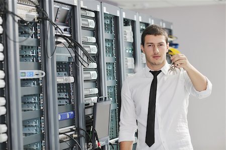 simsearch:400-05881495,k - young handsome business man  engeneer in datacenter server room Stock Photo - Budget Royalty-Free & Subscription, Code: 400-04779220