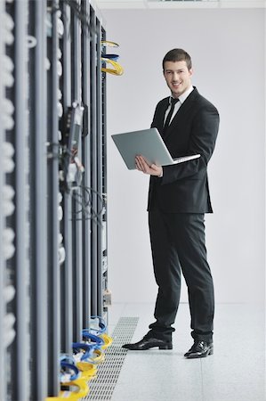 simsearch:400-05291415,k - young engeneer business man with thin modern aluminium laptop in network server room Stock Photo - Budget Royalty-Free & Subscription, Code: 400-04779221