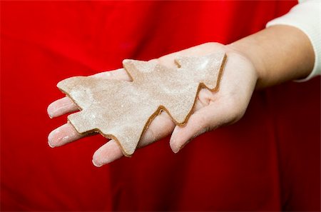 simsearch:400-05721521,k - Woman holding a homemade Gingerbread cookie with a shape of a Christmas tree Stock Photo - Budget Royalty-Free & Subscription, Code: 400-04770035
