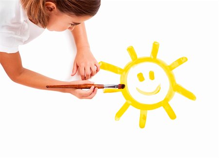 Top view of a happy girl lying on floor and painting a happy sun Stock Photo - Budget Royalty-Free & Subscription, Code: 400-04773562