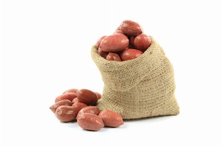 Still life picture of Unshelled Pecan Nuts with shells in burlap bag and spilled on pile over white background. Stock Photo - Budget Royalty-Free & Subscription, Code: 400-04784630