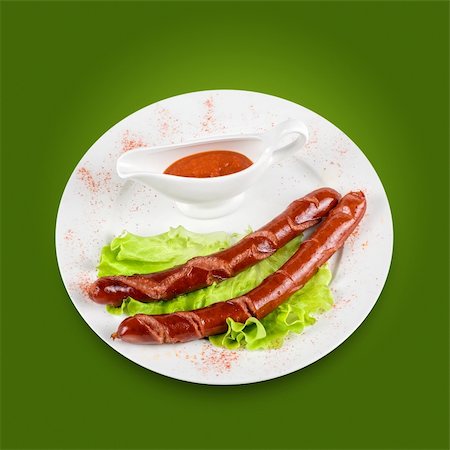 simsearch:400-04587885,k - grilled sausage with lettuce and sauce on green background Stock Photo - Budget Royalty-Free & Subscription, Code: 400-04788386