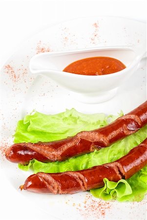 simsearch:400-04587885,k - grilled sausage closeup with lettuce and sauce isolated on white Stock Photo - Budget Royalty-Free & Subscription, Code: 400-04788387