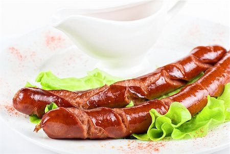 simsearch:400-04587885,k - grilled sausage closeup with lettuce and sauce isolated on white Stock Photo - Budget Royalty-Free & Subscription, Code: 400-04788389
