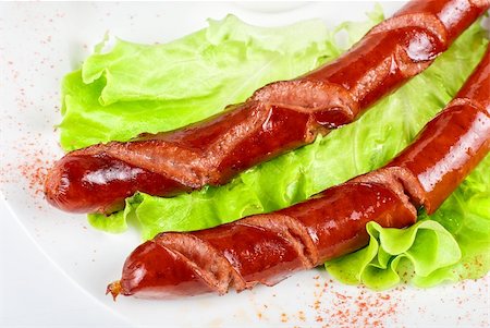 simsearch:400-04587885,k - grilled sausage closeup with lettuce and sauce isolated on white Stock Photo - Budget Royalty-Free & Subscription, Code: 400-04788390
