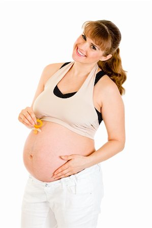 simsearch:400-04817039,k - Smiling pregnant woman holding  baby dummy near belly isolated on white Stock Photo - Budget Royalty-Free & Subscription, Code: 400-04789399