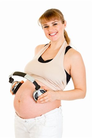 simsearch:400-04817039,k - Smiling pregnant woman holding headphones on her belly isolated on white Stock Photo - Budget Royalty-Free & Subscription, Code: 400-04789401