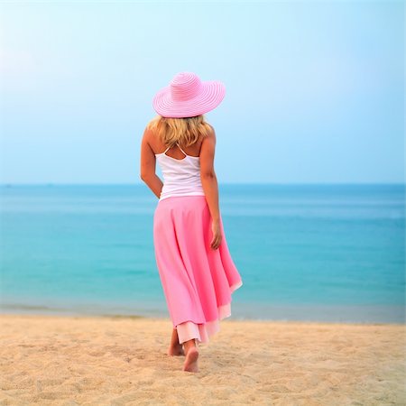 Woman walking near the ocean in pink clothes Stock Photo - Budget Royalty-Free & Subscription, Code: 400-04782888
