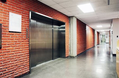 simsearch:400-04333419,k - One freight stainless steel door elevator surrounded by brcik wall of a deserted hallway. Could be office, school, retirement home and hospital. Stock Photo - Budget Royalty-Free & Subscription, Code: 400-04783745