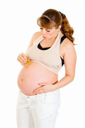 simsearch:400-04817039,k - Pregnant woman holding  baby dummy near belly isolated on white Stock Photo - Budget Royalty-Free & Subscription, Code: 400-04798380