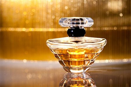 Bottle of perfume with reflection on shiny gold background Stock Photo - Budget Royalty-Free & Subscription, Code: 400-04791015