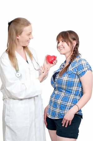 A female cardiologist holding a red heart while talikng to a patient Stock Photo - Budget Royalty-Free & Subscription, Code: 400-04791227