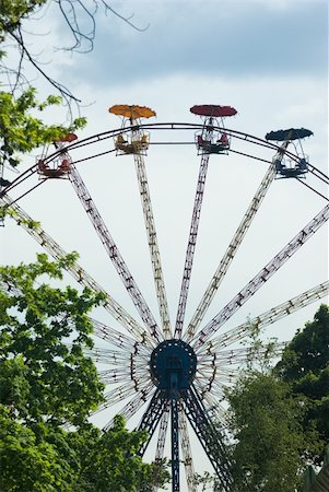 Popular attraction in park - a Ferris wheel on a background of the cloudy blue sky Stock Photo - Budget Royalty-Free & Subscription, Code: 400-04791236