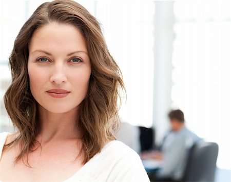 simsearch:400-05746962,k - Portrait of a charismatic woman at a meeting while her team working in the background Stock Photo - Budget Royalty-Free & Subscription, Code: 400-04791822