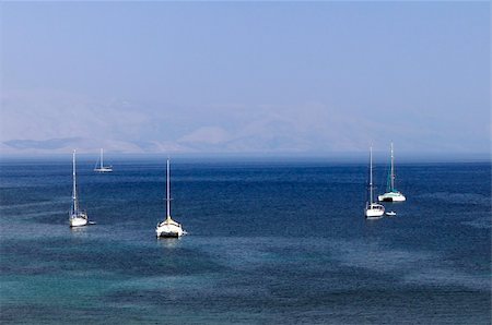 Sailboats at anchor on the sea near the shore Stock Photo - Budget Royalty-Free & Subscription, Code: 400-04793526