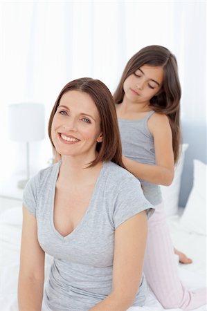 simsearch:400-04151135,k - Lovely daughter brushing her woman hair at home Stock Photo - Budget Royalty-Free & Subscription, Code: 400-04804394
