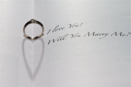 simsearch:400-04839979,k - Ring casting heart shadow in book with the sentence "I Love You! Will You Marry Me?" Stock Photo - Budget Royalty-Free & Subscription, Code: 400-04807880