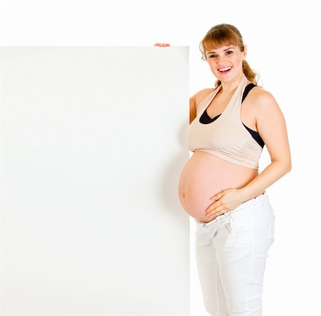 simsearch:400-04798379,k - Smiling beautiful pregnant woman holding blank billboard  isolated on white Stock Photo - Budget Royalty-Free & Subscription, Code: 400-04808798