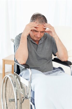 Senior in his wheelchair having a headache at home Stock Photo - Budget Royalty-Free & Subscription, Code: 400-04809136