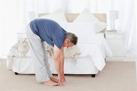 Mature man stretching in his bedroom Stock Photo - Budget Royalty-Free & Subscription, Code: 400-04809151