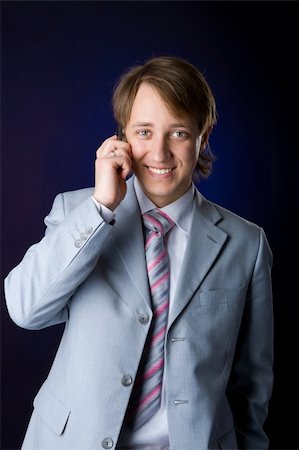 Businessman talking on cell phone over dark background Photographie de stock - Aubaine LD & Abonnement, Code: 400-04815764