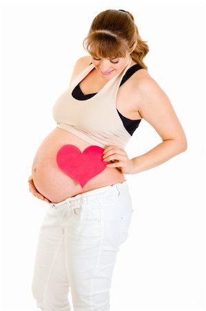 simsearch:400-04817039,k - Smiling pregnant woman holding heart near her tummy isolated on white Stock Photo - Budget Royalty-Free & Subscription, Code: 400-04817041