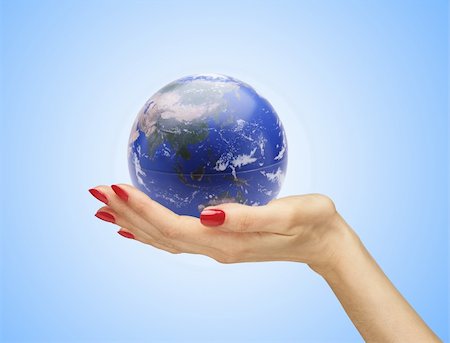simsearch:400-06089187,k - Hand with the world (globe) over blue background Stock Photo - Budget Royalty-Free & Subscription, Code: 400-04818175