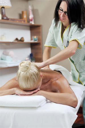 simsearch:400-05352124,k - A pretty woman getting a shoulder and back massage at spa and wellness center Stock Photo - Budget Royalty-Free & Subscription, Code: 400-04812048