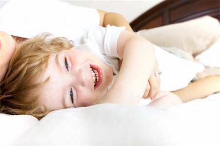 Mother and Son laughing and playing in bed. Stock Photo - Budget Royalty-Free & Subscription, Code: 400-04812778