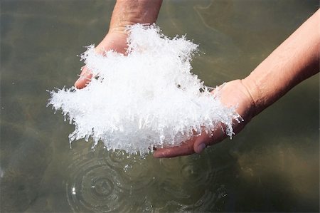 Hand holding salt crystals from salt lake above the water surface Stock Photo - Budget Royalty-Free & Subscription, Code: 400-04829969