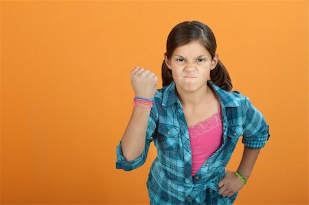 simsearch:400-06363059,k - Brave angry little Latino kid on an orange background Stock Photo - Budget Royalty-Free & Subscription, Code: 400-04834978