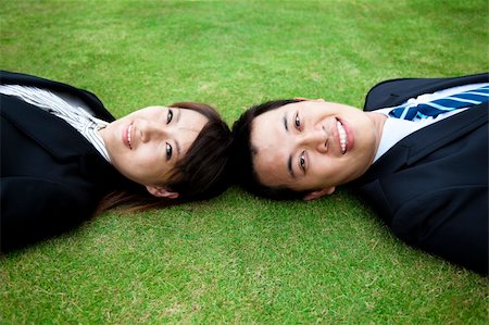 Attractive young adult couple and lay on the grass field Stock Photo - Budget Royalty-Free & Subscription, Code: 400-04839921