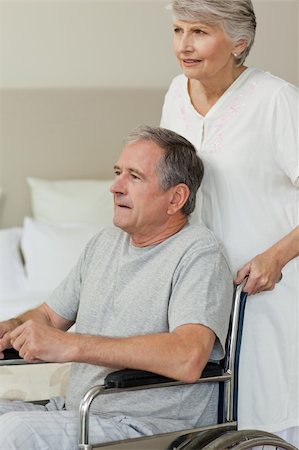 Retired man in his wheelchair with his wife Stock Photo - Budget Royalty-Free & Subscription, Code: 400-04830303