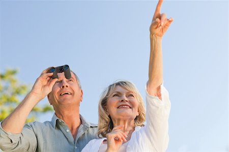 Couple looking at the sky with their binoculars Stock Photo - Budget Royalty-Free & Subscription, Code: 400-04830989