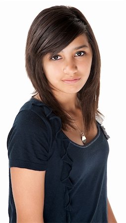 Cute hispanic teenage girl looking casual on white background Photographie de stock - Aubaine LD & Abonnement, Code: 400-04831172
