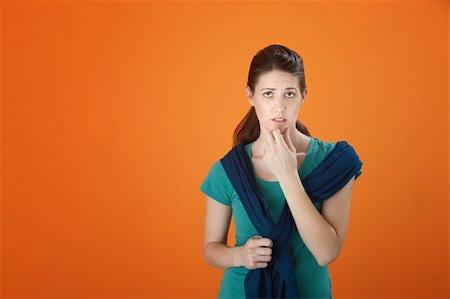 simsearch:400-05388090,k - Woman with fingers on chin must make a choice. Stock Photo - Budget Royalty-Free & Subscription, Code: 400-04831239