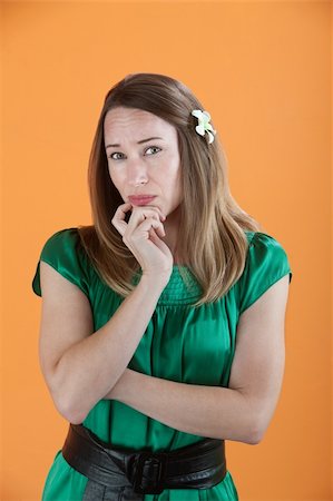 Concerned beautiful Caucasian isolated on an orange background Stock Photo - Budget Royalty-Free & Subscription, Code: 400-04831248