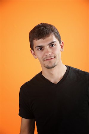 Confident and handsome Mexican American teen isolated on an orange background Stock Photo - Budget Royalty-Free & Subscription, Code: 400-04831308