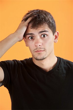 Forgetful Native American teen on orange background Stock Photo - Budget Royalty-Free & Subscription, Code: 400-04831309
