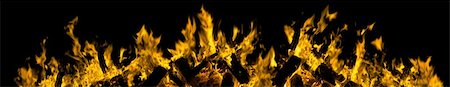 simsearch:614-03763965,k - fiery blazing yellow tongues of flames in a  fire border isolated on black background Stock Photo - Budget Royalty-Free & Subscription, Code: 400-04831953