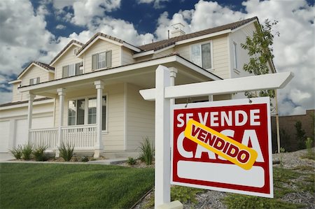 simsearch:693-03308239,k - Vendido Se Vende Casa Spanish Real Estate Sign and House and Blue Sky with Clouds. Stock Photo - Budget Royalty-Free & Subscription, Code: 400-04832096