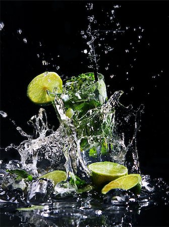Fresh drink with splashesh of water, green mint and lime on black background Stock Photo - Budget Royalty-Free & Subscription, Code: 400-04832166