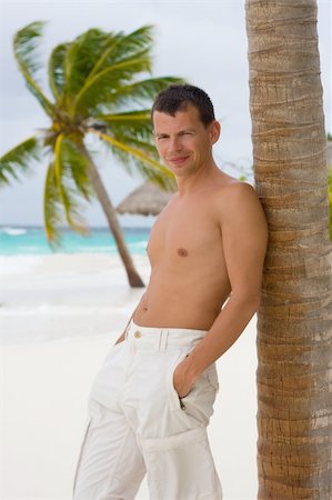 Young man on a tropical beach in the morning during a gale Stock Photo - Budget Royalty-Free & Subscription, Code: 400-04832760