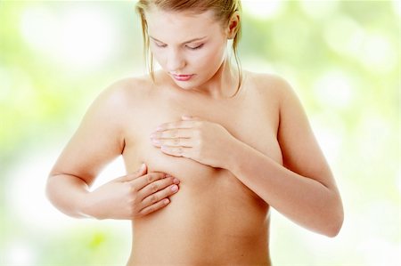 Young Caucasian adult woman examining her breast for lumps or signs of breast cancer Stock Photo - Budget Royalty-Free & Subscription, Code: 400-04844899