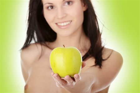 Nude young woman with a green juicy apple - focused on apple Photographie de stock - Aubaine LD & Abonnement, Code: 400-04845017