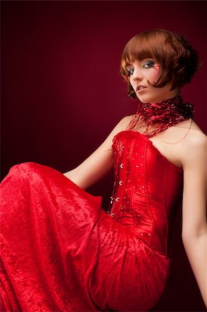 simsearch:400-04653285,k - Beautiful girl in red dress over on red background Photographie de stock - Aubaine LD & Abonnement, Code: 400-04847616